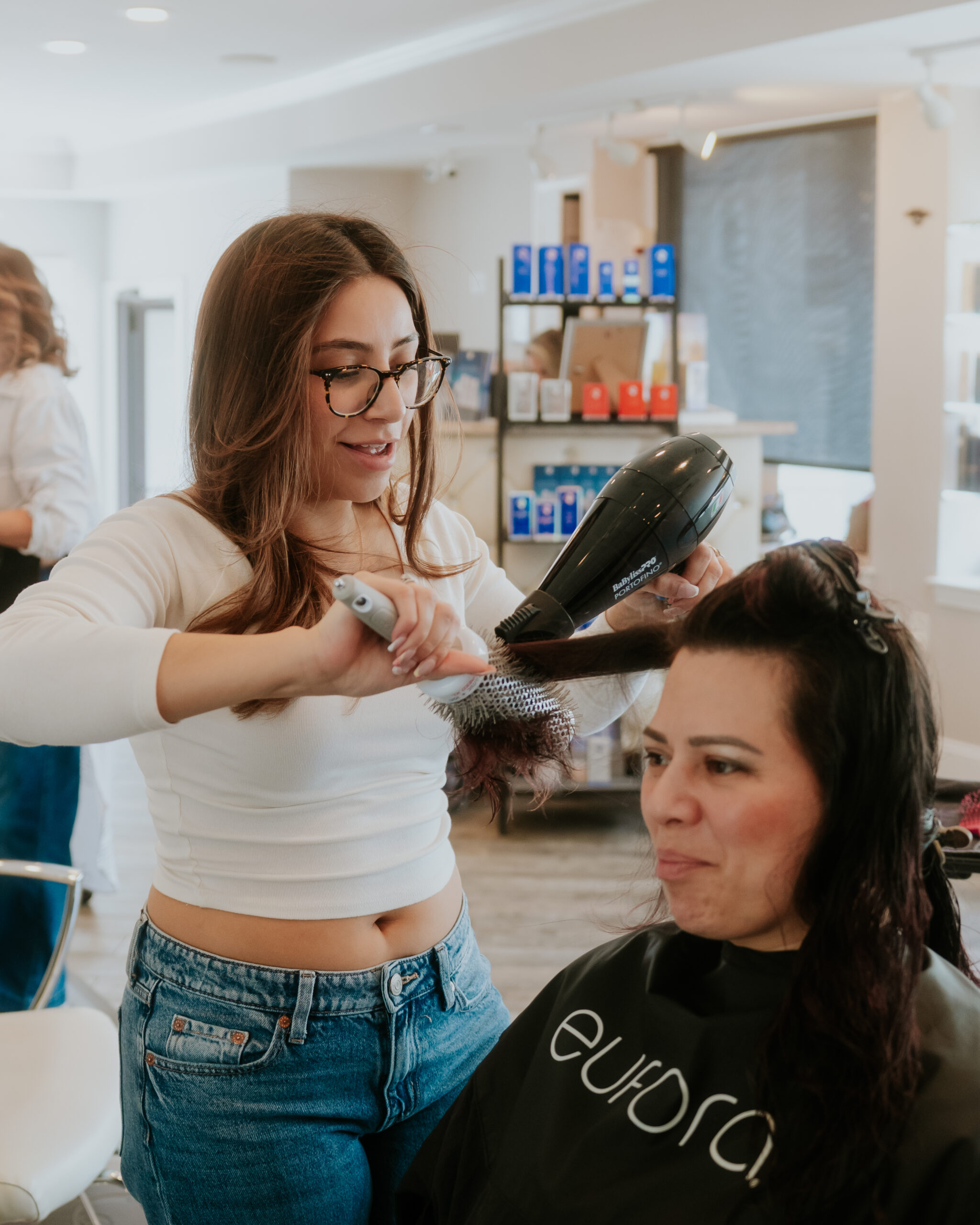Hair stylist performing blowout service in Boston